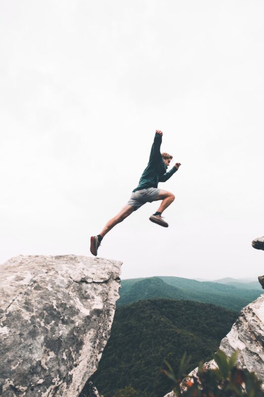 Man jumping over rocks