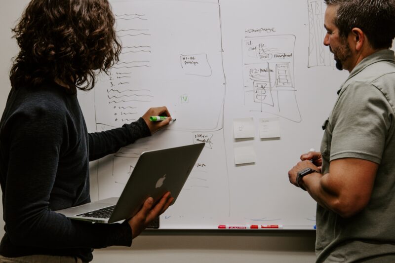 People writing on a whiteboard